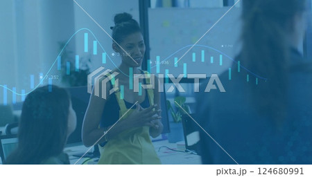Image of financial data processing over diverse business people in office Image of financial data processing over diverse business people in office 124680991