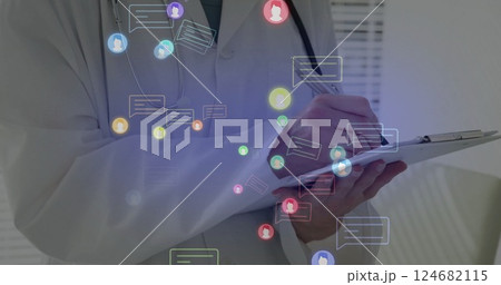 Image of media icons over caucasian male doctor writing 124682115