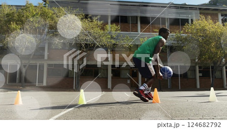 Running basketball drill, athlete training over lens flare image Running basketball drill, athlete training over lens flare image 124682792