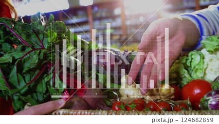 Hands picking vegetables from basket, bar chart image over produce 124682859
