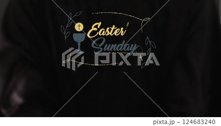 Image of eastersunday text with biracial woman's hands on black background 124683240