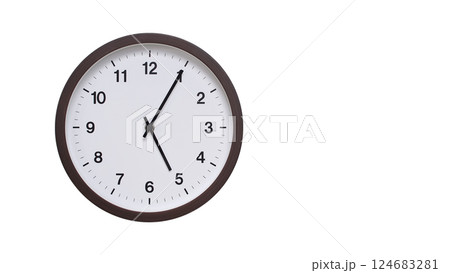 A simple round wall clock with a dark brown frame and a white face displaying 05:05/17:05. Isolated on a white background, perfect for time-related concepts, deadlines, and schedule themes. 124683281
