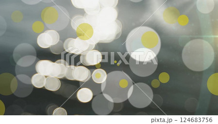 Image of glowing light spots moving over grey background 124683756