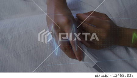 Image of cardiographs over senior biracial woman lying in hospital bed Image of cardiographs over senior biracial woman lying in hospital bed 124683838