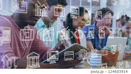 Image of business icons over diverse colleagues using technology in office Image of business icons over diverse colleagues using technology in office 124683914