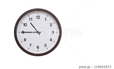 A simple round wall clock with a dark brown frame and a white face displaying 10:45/22:45. Isolated on a white background, perfect for time-related concepts, deadlines, and schedule themes. A simple round wall clock with a dark brown frame and a white face displaying 10:45/22:45. Isolated on a white background, perfect for time-related concepts, deadlines, and schedule themes. 124683973
