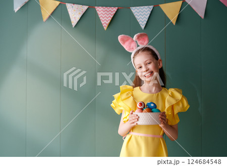 child with Easter painting eggs child with Easter painting eggs 124684548