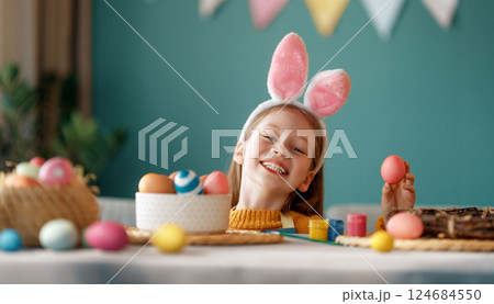 child with Easter painting eggs child with Easter painting eggs 124684550