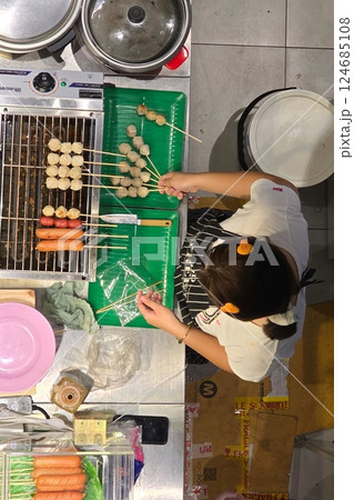 Grilling meatballs and sausages, seen from overhead Grilling meatballs and sausages, seen from overhead 124685108