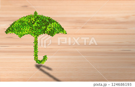 Eco-Friendly Protection: Leafy Umbrella Symbolizing Natural Shield on Wooden Background Eco-Friendly Protection: Leafy Umbrella Symbolizing Natural Shield on Wooden Background 124686193