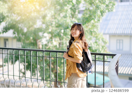 traveler young Asian woman in her 30s navigates the vibrant streets of Bangkok. Let this photo inspire your own journey. traveler young Asian woman in her 30s navigates the vibrant streets of Bangkok. Let this photo inspire your own journey. 124686599