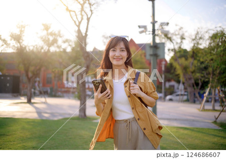 traveler young Asian woman in her 30s navigates the vibrant streets of Bangkok. Let this photo inspire your own journey. 124686607