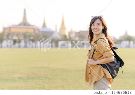 A Traveler Asian woman in her 30s exploring Wat Pra Kaew. From stunning architecture to friendly locals, she cherishes every moment, capturing it all in her heart and camera for years to come. A Traveler Asian woman in her 30s exploring Wat Pra Kaew. From stunning architecture to friendly locals, she cherishes every moment, capturing it all in her heart and camera for years to come. 124686618