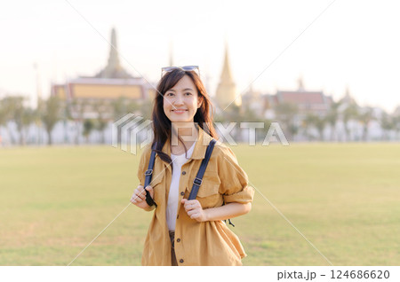 A Traveler Asian woman in her 30s exploring Wat Pra Kaew. From stunning architecture to friendly locals, she cherishes every moment, capturing it all in her heart and camera for years to come. A Traveler Asian woman in her 30s exploring Wat Pra Kaew. From stunning architecture to friendly locals, she cherishes every moment, capturing it all in her heart and camera for years to come. 124686620