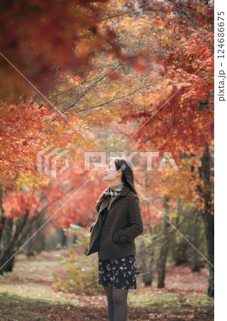 Portrait of a young Asian woman with autumn leaves 124686675