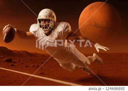 football player in white uniform dives with the ball on red landscape, with large planet in sky on background. Surreal scene blends American football with sci-fi setting. 124686892