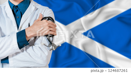 Doctor with stethoscope on Scottish flag. Doctor holding stethoscope on Scotland flag Doctor with stethoscope on Scottish flag. Doctor holding stethoscope on Scotland flag 124687261