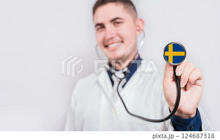 Doctor showing stethoscope with Swedish flag. Sweden national healthcare concept 124687318