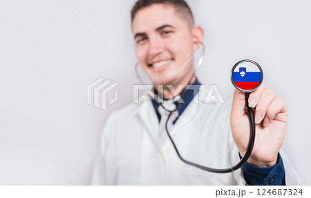 Doctor showing stethoscope with Slovenian flag. Slovenia national healthcare concept Doctor showing stethoscope with Slovenian flag. Slovenia national healthcare concept 124687324
