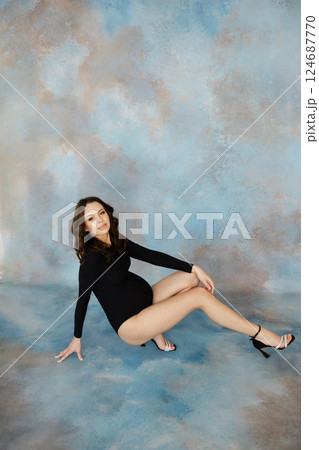 Confident Woman Posing in Stylish Black Outfit 124687770