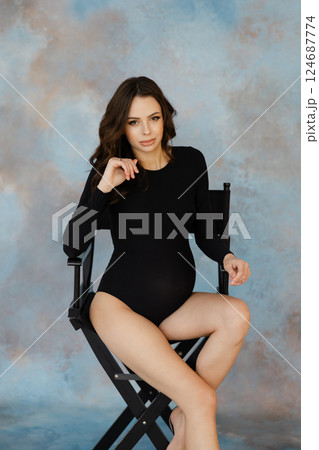 Expectant Mother Sitting on Director's Chair Expectant Mother Sitting on Director's Chair 124687774