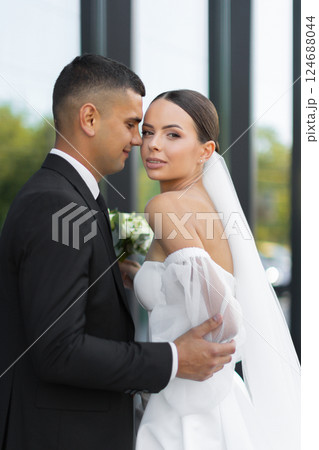 Groom embracing bride during wedding day Groom embracing bride during wedding day 124688044