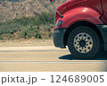 Heavy-duty vehicle tire in motion on asphalt. 124689005