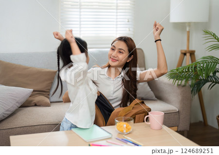 Celebrating School Readiness and Family Love. A joyful mother and her daughter share a moment of excitement before school. 124689251