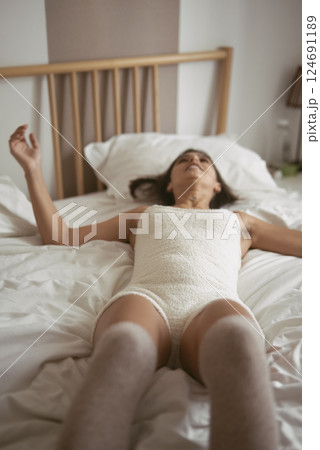 Serene Moments in Bed A Beautiful Portrait of Relaxation, Comfort, and Peacefulness Serene Moments in Bed A Beautiful Portrait of Relaxation, Comfort, and Peacefulness 124691189
