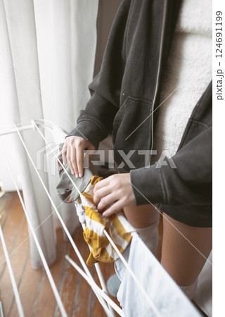 A cozy indoor scene with laundry and casual attire, creating a warm, inviting atmosphere A cozy indoor scene with laundry and casual attire, creating a warm, inviting atmosphere 124691199
