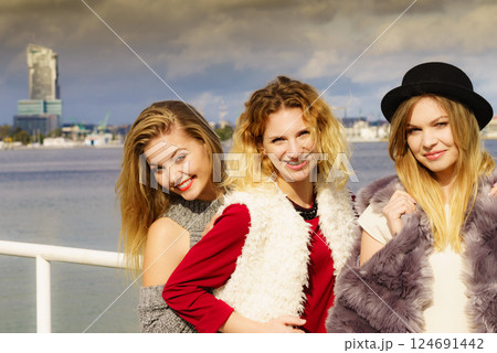 Positive female friends having fun outdoor Positive female friends having fun outdoor 124691442