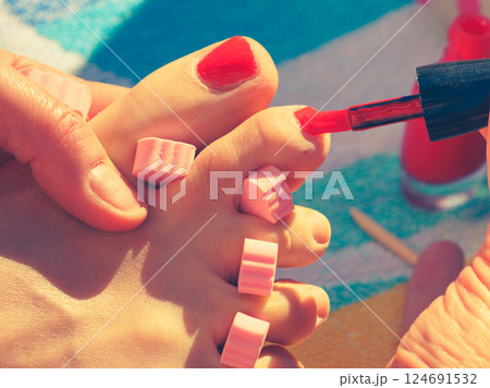Woman pedicure with red nail polish Woman pedicure with red nail polish 124691532