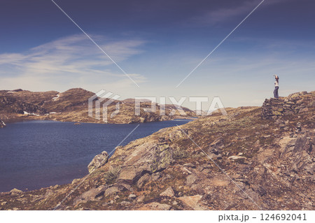 Tourist enjoying landscape norwegian nature Tourist enjoying landscape norwegian nature 124692041