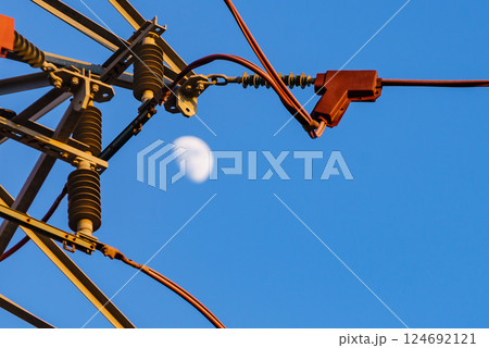 High voltage towers against blue sky High voltage towers against blue sky 124692121