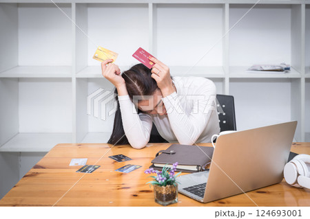Stressful asian businesswoman with huge amount of credit card debt. 124693001