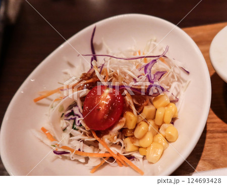 close up of cherry tomato, sweet corns, shredded cabbage, purple cabbage, shredded carrots, and served in white bowl close up of cherry tomato, sweet corns, shredded cabbage, purple cabbage, shredded carrots, and served in white bowl 124693428