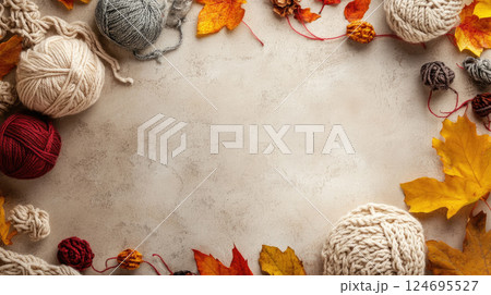 Flat-lay view of autumn composition with thread balls and beautiful leaves on light beige concrete background. 124695527