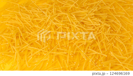 Raw vermicelli textured background, gold soup pasta pattern, small homemade noodles mock up 124696169