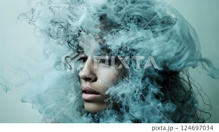 Woman with Dark Curly Hair Partially Obscured by Turquoise Smoke or Clouds, Beauty Portrait 124697034