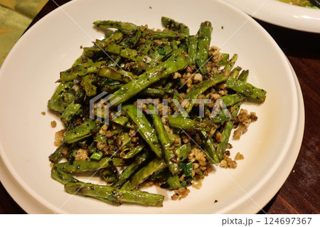close up of Chinese stir fried green beans in Sichuan style with minced pork, garlic, spice and green beans on a white plate close up of Chinese stir fried green beans in Sichuan style with minced pork, garlic, spice and green beans on a white plate 124697367