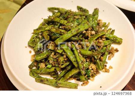 close up of Chinese stir fried green beans in Sichuan style with minced pork, garlic, spice and green beans on a white plate close up of Chinese stir fried green beans in Sichuan style with minced pork, garlic, spice and green beans on a white plate 124697368