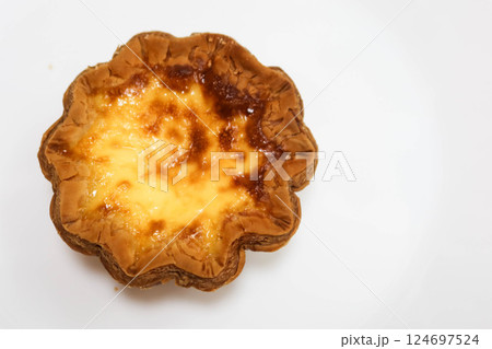 close up of baked flower shape Portuguese egg tart on a white background 124697524