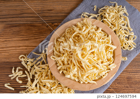 Passatelli spatzle pasta in bowl, raw spaetzle noodles, dry homemade german macaroni 124697594