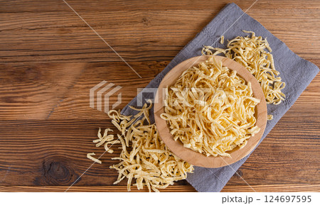 Passatelli spatzle pasta in bowl, raw spaetzle noodles, dry homemade german macaroni 124697595