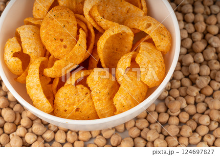 Hummus chickpea chips, chick pea crisps pile, healthy orange snack, fried legume crunchies 124697827
