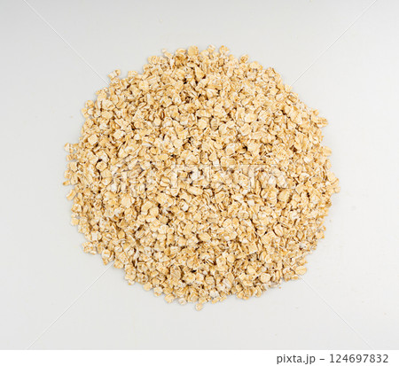 Dry raw oat flakes isolated, rolled flat grains, instant porridge, thin cereals, flattened grains group Dry raw oat flakes isolated, rolled flat grains, instant porridge, thin cereals, flattened grains group 124697832