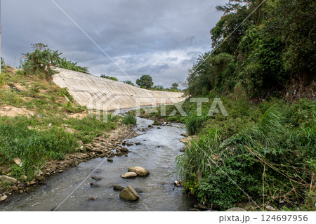The riverbank of Ylang Ylang River in Cavite, Philippines at a low water level The riverbank of Ylang Ylang River in Cavite, Philippines at a low water level 124697956