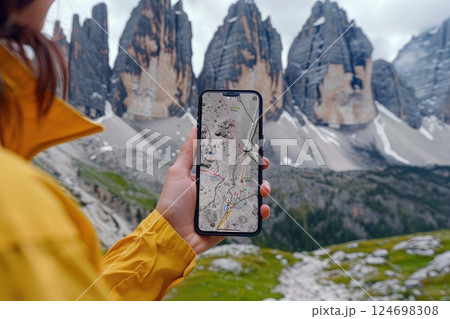 Female hiker using smartphone's GPS app in mountain travel. 124698308
