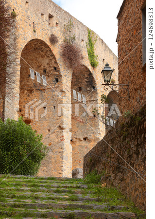 Stone steps between medieval walls of houses in bay of Porto Venere, Liguria. Tourism in Italy. Traditional buildings. Background for design.  124698313