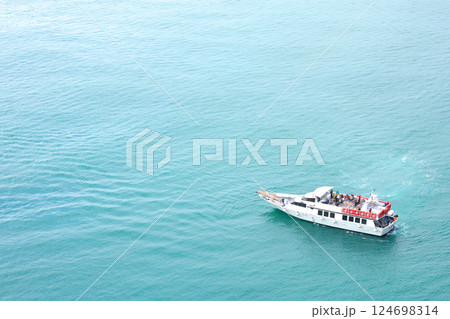Tourist boat with passengers in bay of Porto Venere, Liguria. Sea and tourism on sea transportation in Italy. Background for design. Tourist boat with passengers in bay of Porto Venere, Liguria. Sea and tourism on sea transportation in Italy. Background for design. 124698314